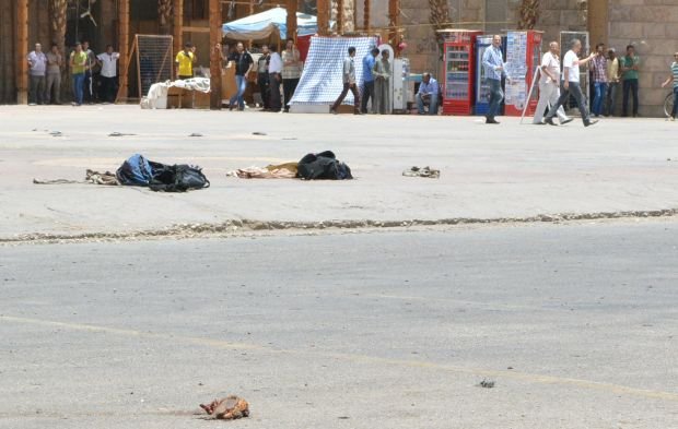 Remains of a body of a suicide bomber is seen near blast detonation equipment at the scene of a foiled suicide attack in Luxor