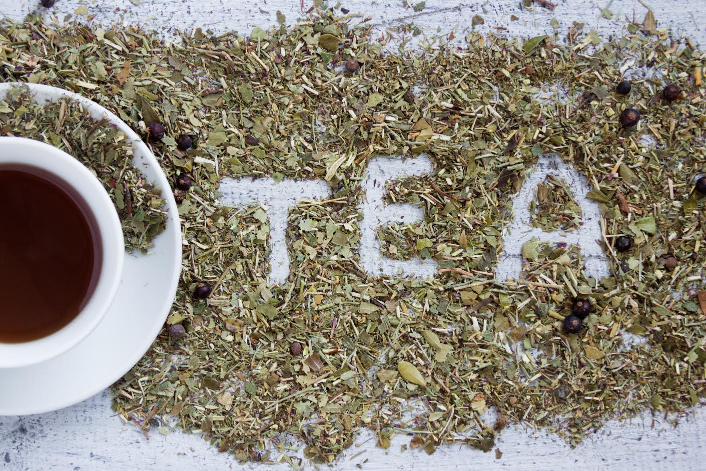 Cup of tea with the word TEA written in dry herbs