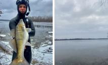 Чоловік, який пірнув у крижаний Дніпро, аби вполювати рибку, похизувався величезним судаком